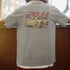 Person wearing a gray t-shirt with a car graphic and '24H' text on the back.